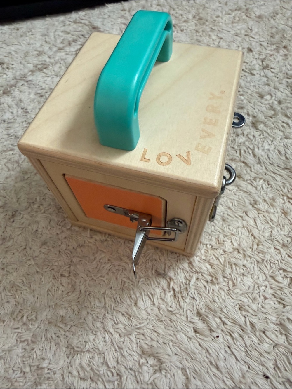 Lovevery Wooden Busy Box with Teal Handle and Orange Door